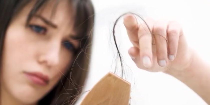 girl with holding dry, broken hair