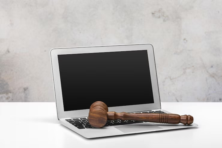 Laptop with a mallet on the table - Law personal statement tips.