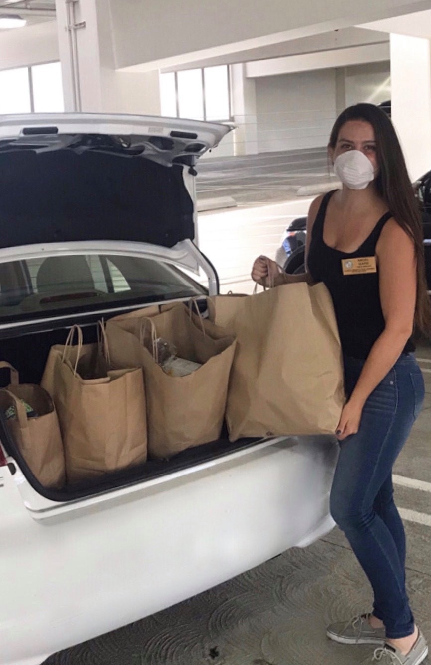 Councilmember Koretz staff loads grocery bags into car for food bank