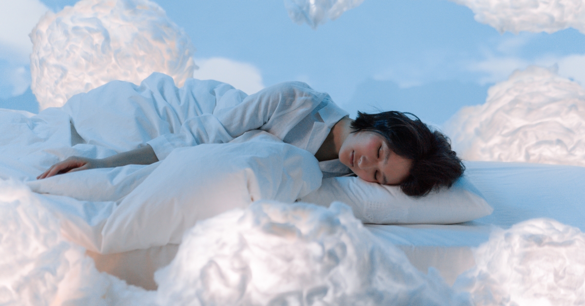 woman sleeping on a bed in the clouds