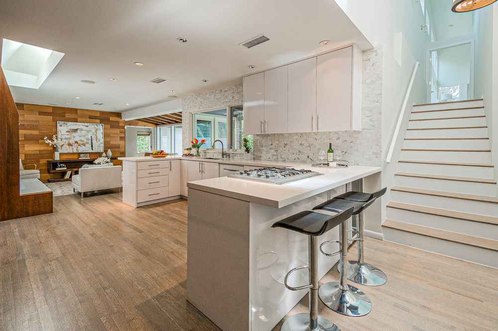 kitchen stone backsplash white new light walnut stained floors renovation and home staging roi dallas