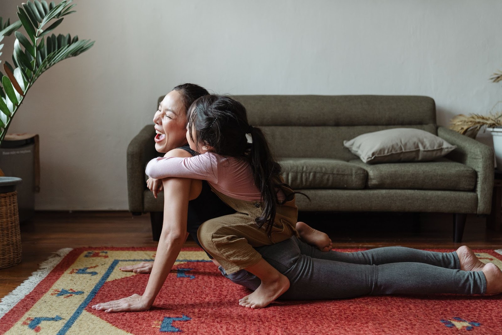mother and daughter laughing, yoga, fitness, health, parenting