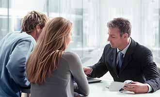 A Massachusetts motorcycle accident lawyer meets with his two clients.