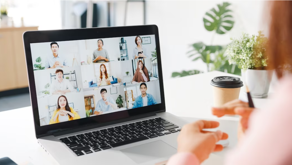 woman has a meeting with her colleagues, coffee and flowers on the table