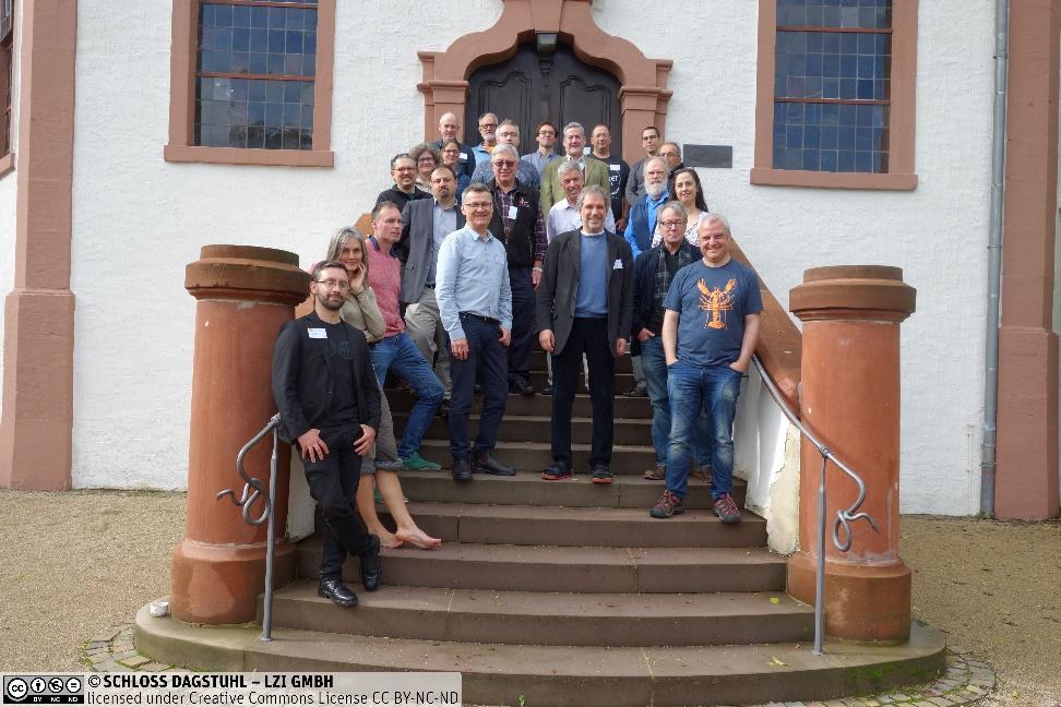 Workshop participants standing in front of the chapel at Schloss Dagstuhl in Wadern, Germany.Description automatically generated