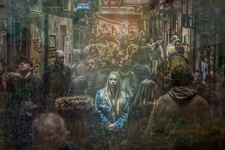 selective focus photography of woman surrounded by people in the street