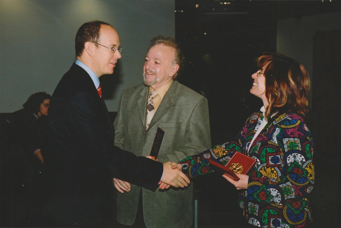 Erga Netz shaking hands with left Prince Albert of Monaco
