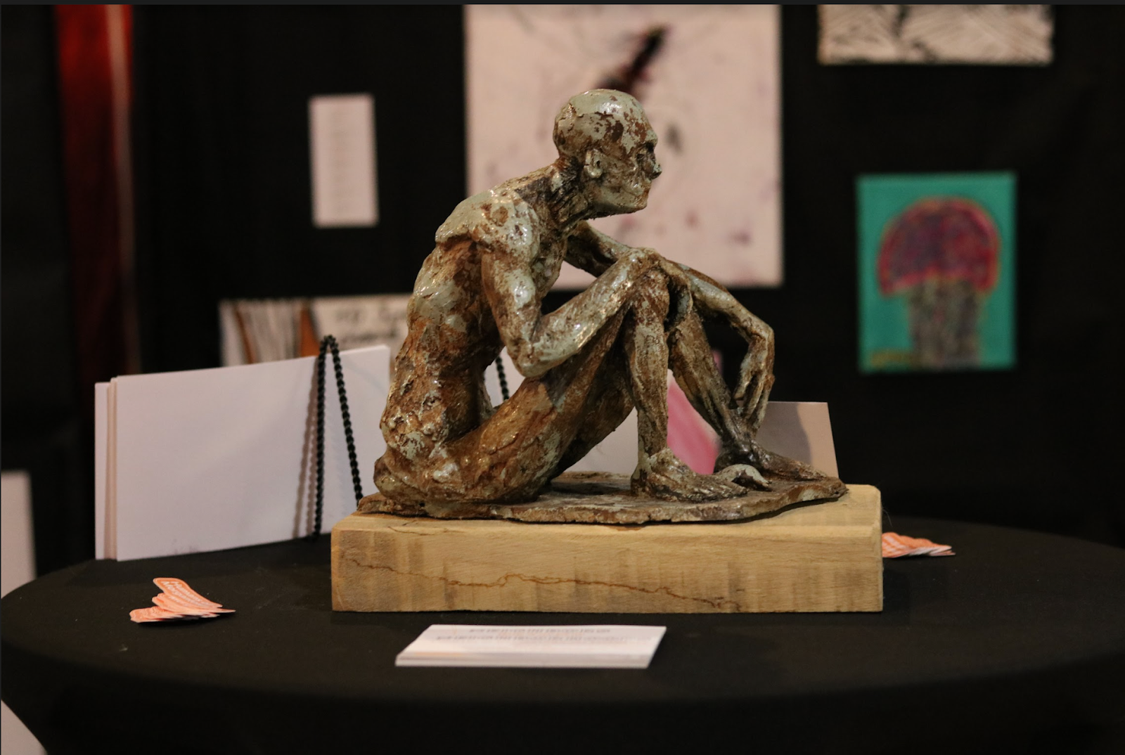 Statue of a man sitting on a wooden block