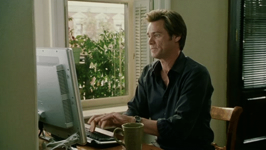GIF of Jim Carrey typing very fast in Bruce Almighty