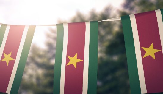 Suriname flag banner on sunny day
