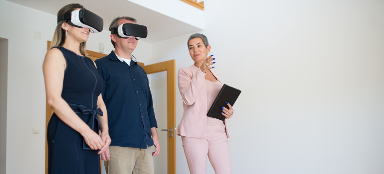 Couple having a VR house tour while a person explains it in more detail