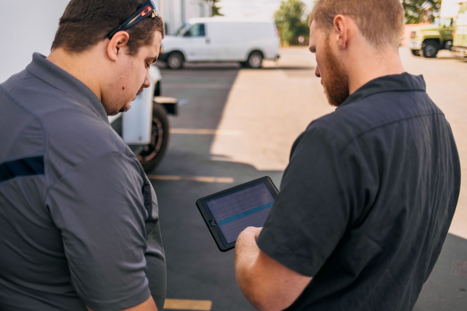 A camera shot of two people staring at a digital tablet