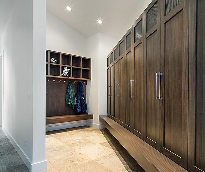 spacious mudroom with brown cabinets and lots of storage