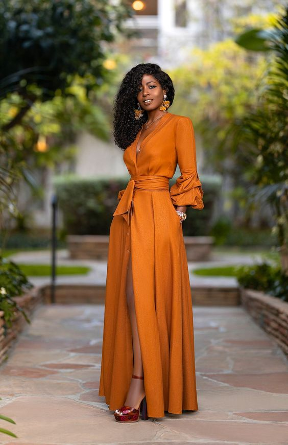 Woman in light brown maxi dress with thigh slit