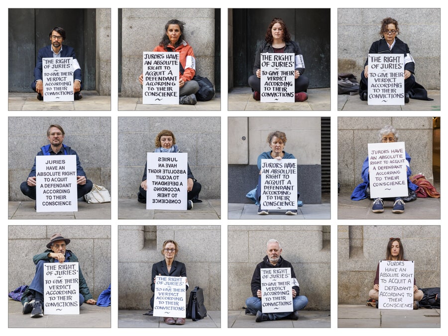 A montage of 12 rebels sat outside different court rooms all holding signs about the right of juries to acquit defendents according to their consciences