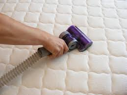 To clean a futon mattress, first vacuum it.