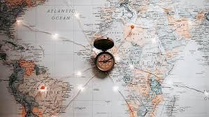 A compass on top of the map of the world