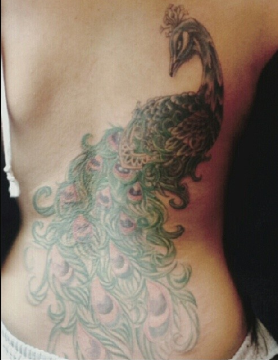 A Light Green Colored Peacock Tattoo