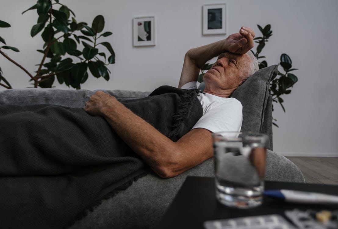 A Sick Elderly Man Lying Down on Sofa