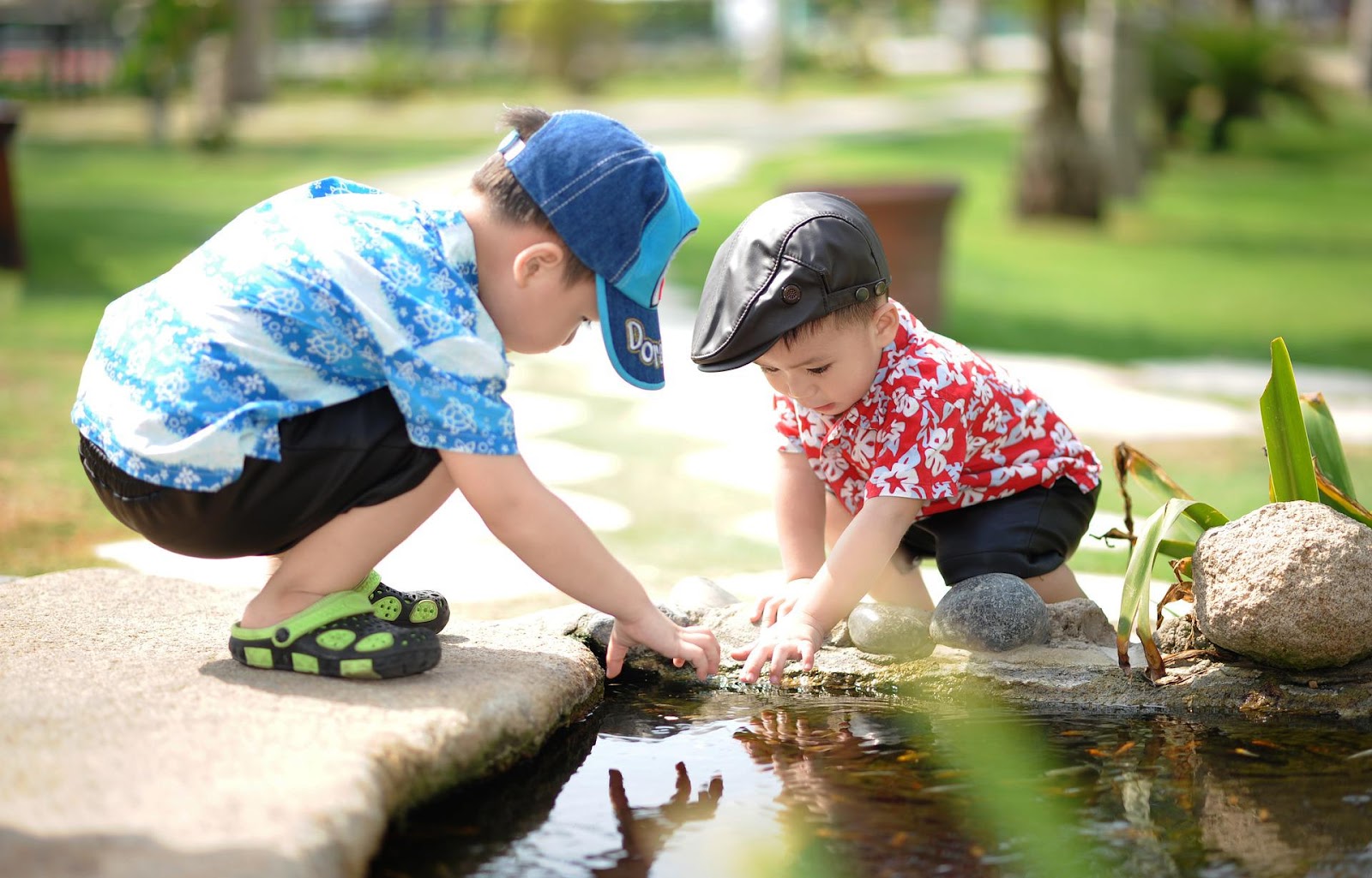 Two preschool children playing together in water