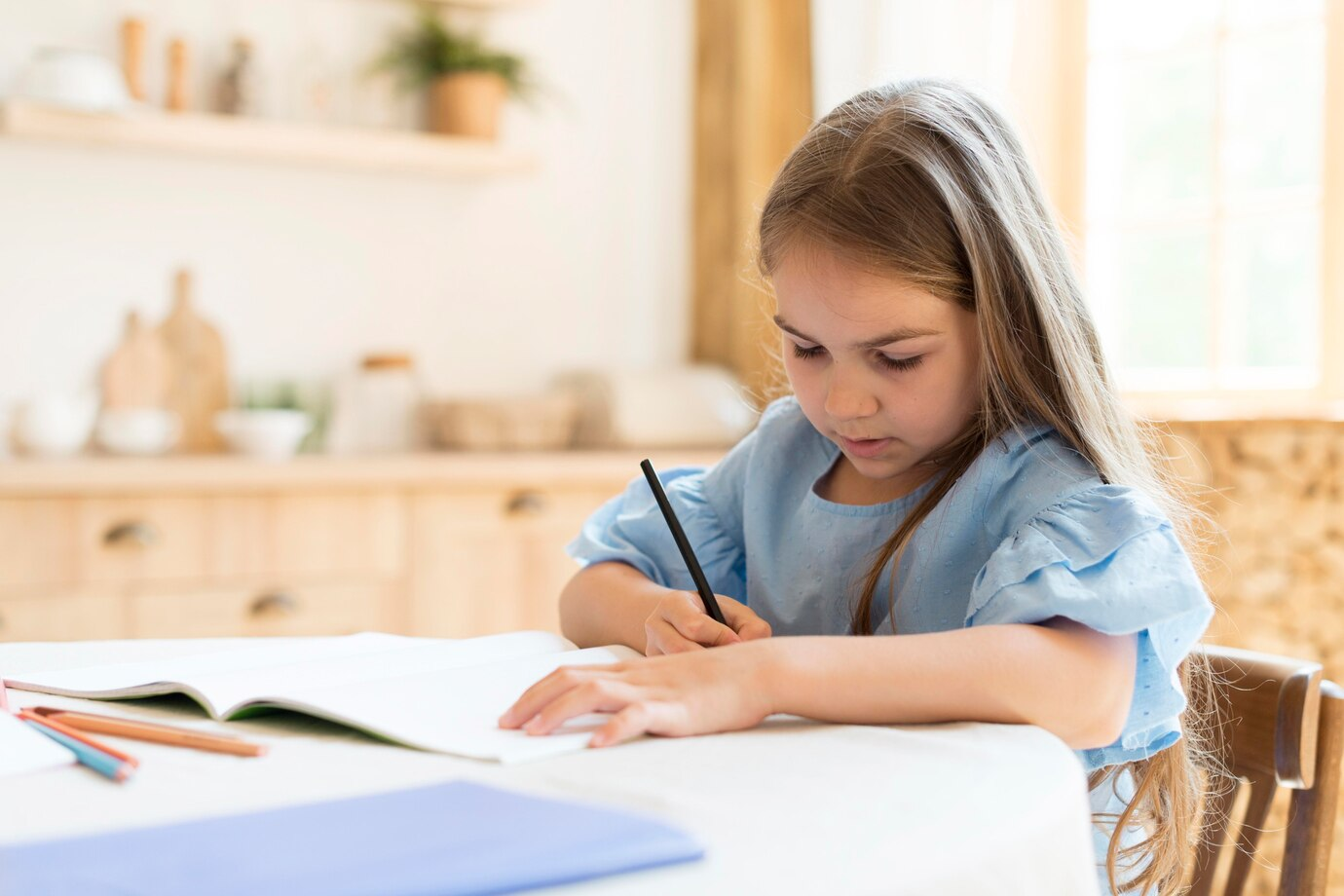 A little girl writing an essay
