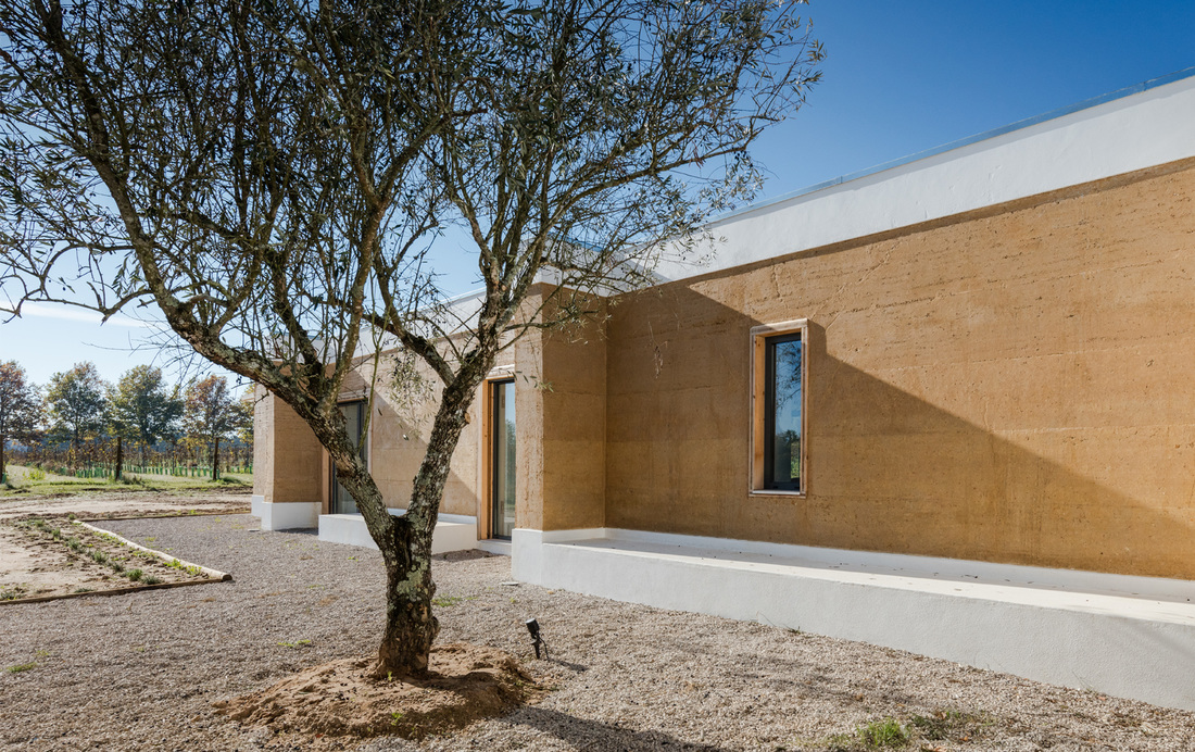 The exposed rammed earth walls of the building