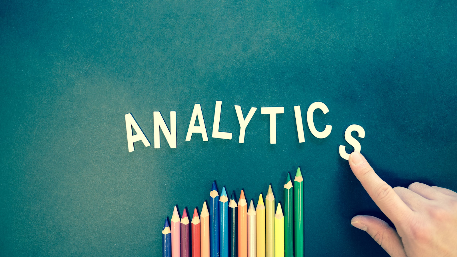 "analytics" is spelled out with colored pens representing a line graph which is important to keep track of the effectiveness of you advertising