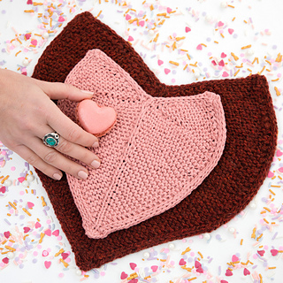 two knitted heart shaped pot holders