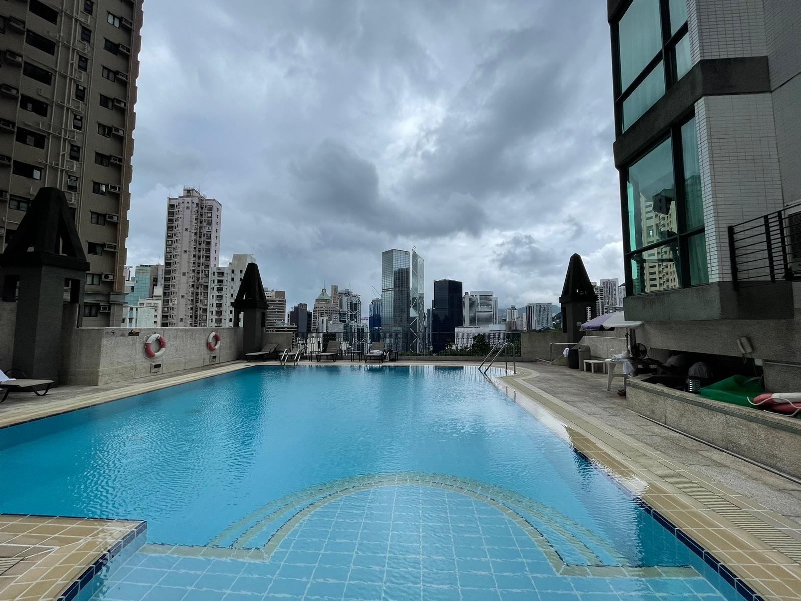 Bishop Lei International house outdoor pool with Hong Kong skyline view