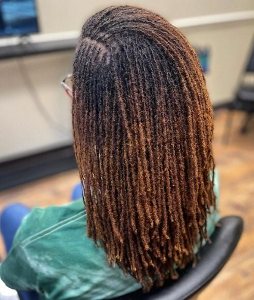 Full picture of a lady showing of black and blond locs