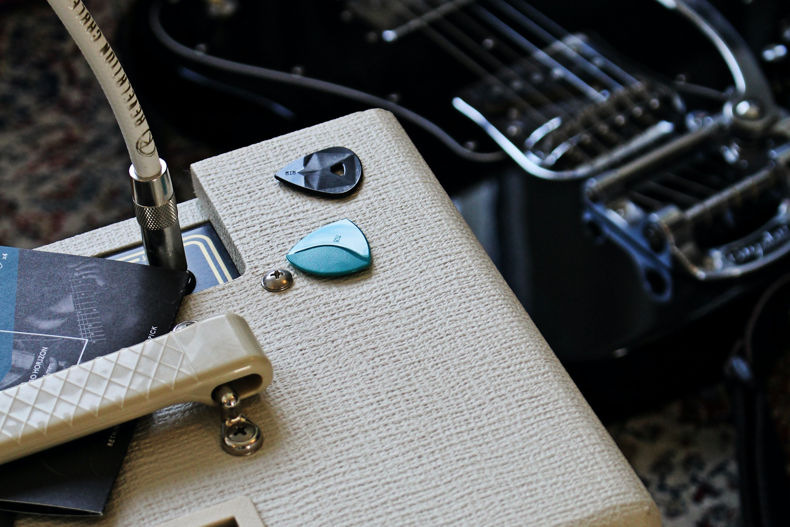 Close up of a guitar amp and picks.