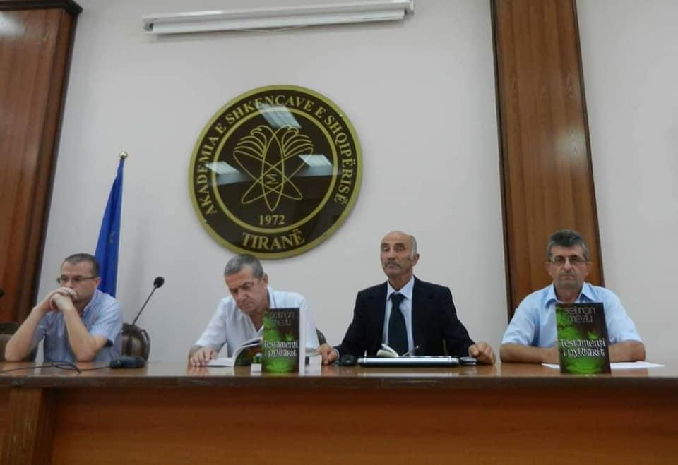 A group of men sitting at a table with microphones

Description automatically generated with medium confidence