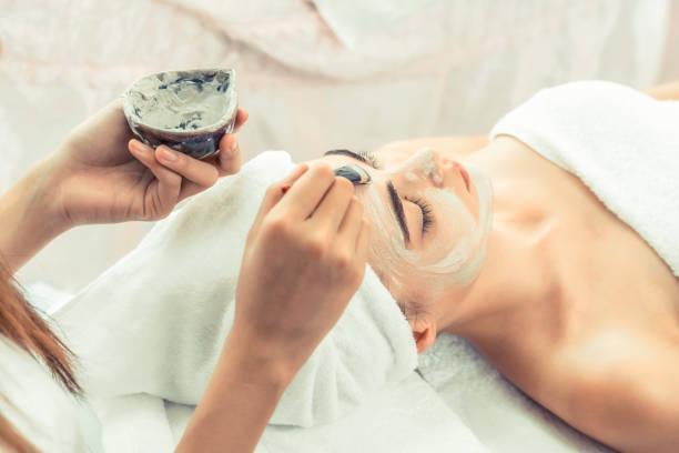 Beautiful woman having a facial treatment at spa.  organic face mask stock pictures, royalty-free photos & images