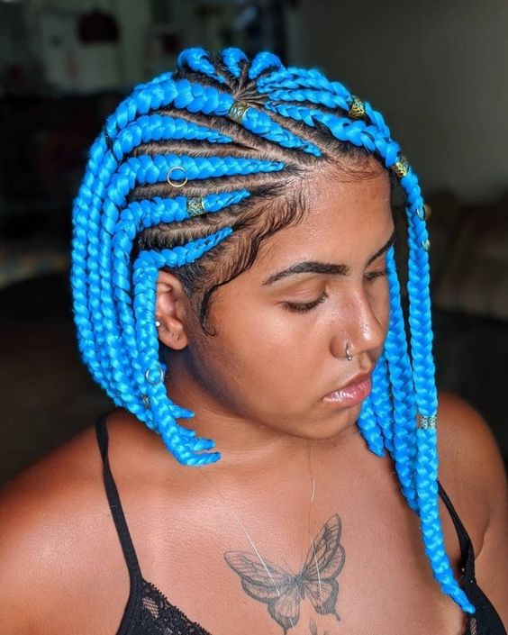 lady with tattoo wearing blue short braiding hair