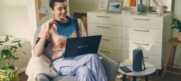 Image of a person with their laptop and the SRS-XE200 X-Series Portable Wireless Speaker