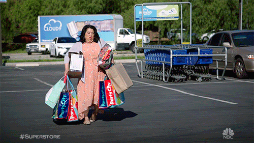A woman carries a lot of shopping bags