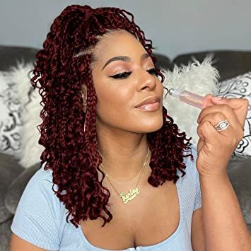 lady with short braids applying makeup