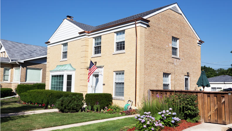 A light-colored, two-story brick home in the Edison Park neighborhood of Chicago. 