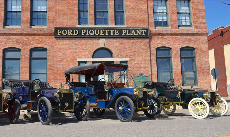 Multiple antique Ford vehicles are on display in front of the Ford Piquette Avenue Plant in Detroit’s Milwaukee Junction neighborhood.