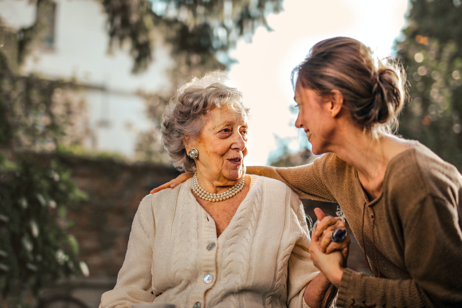 Joyful greeting between a senior and her caregiver