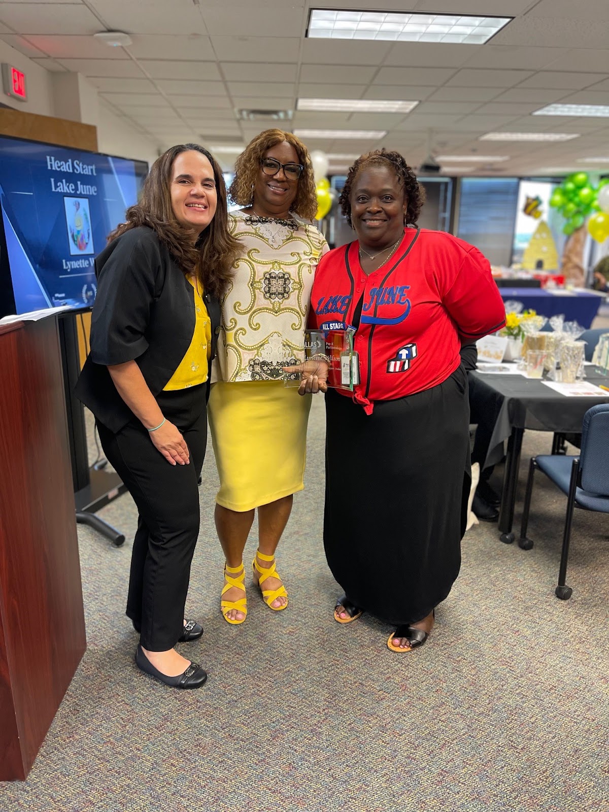 Three Women holding Award