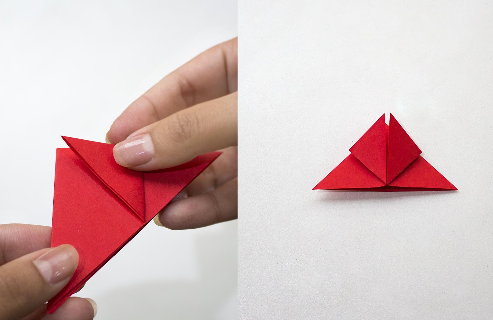 Red sheet of paper with corners of top layers of triangle bent to top