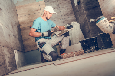 subcontractor trade partner installing tile during remodel custom built