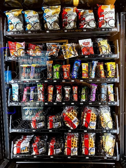 A picture containing shelf, vending machine, different, colorful

Description automatically generated