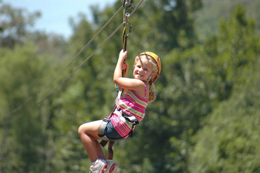 Little girl on zipline smiling