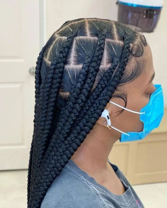 Gorgeous lady on face mask shows off her large knotless braids