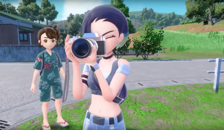 Perrin is aiming her camera into the distance. The player character is looking at Perrin. They are at the edge of town.