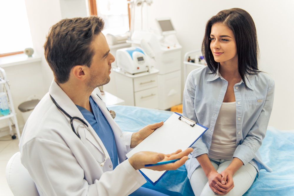 Male doctor talking to a female patient
