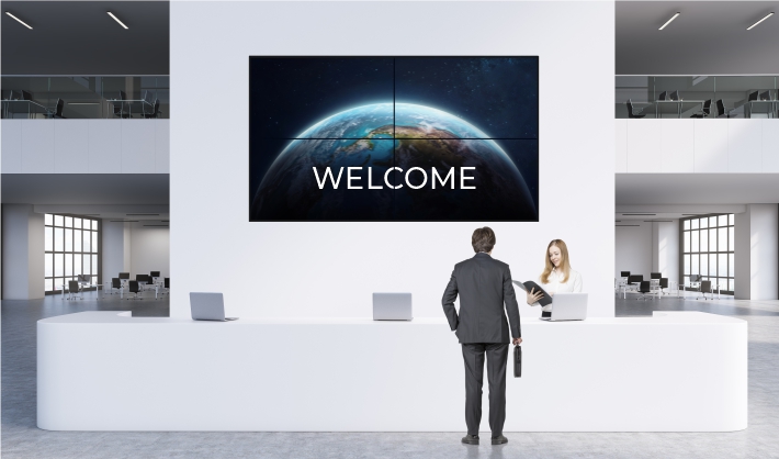 Greet every visitor with a vibrant lobby TV display. Source: Visually Connected. Digital Lobby Signage - Rev Interactive