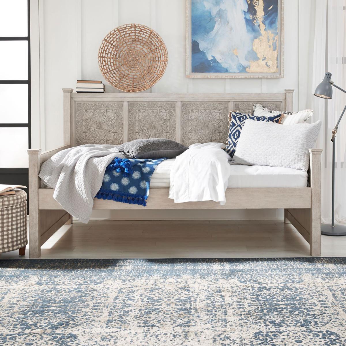 A stylish day bed with a decorative headboard